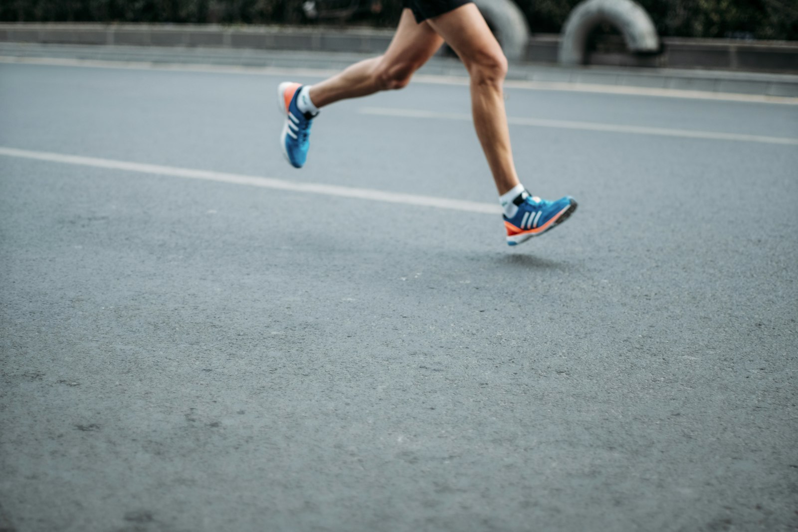 A runner mid-stride on an empty road, the kind of club event Turnout is built around
